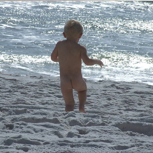 A child standing at the ocean